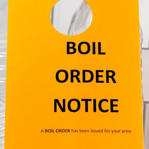 Yellow boil order notice informing residents of a drinking water advisory.