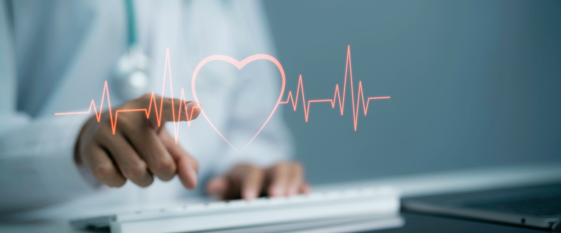 Healthcare professional pointing toward a glowing heart symbol surrounded by an electrocardiogram (ECG) heartbeat line, representing cardiovascular health and heart monitoring.