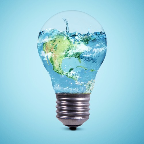 Light bulb filled with water and Earth imagery symbolizing water conservation and environmental sustainability
