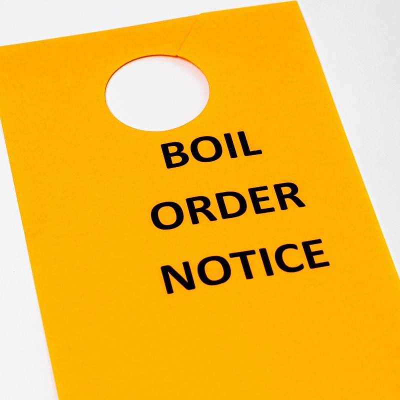 Yellow boil water advisory notice warning residents to boil water before use.